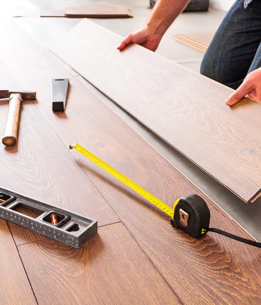 A man laying laminate flooring.