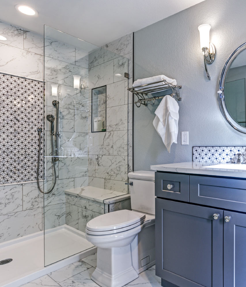 A modern bathroom showcasing a shower, toilet, and sink.